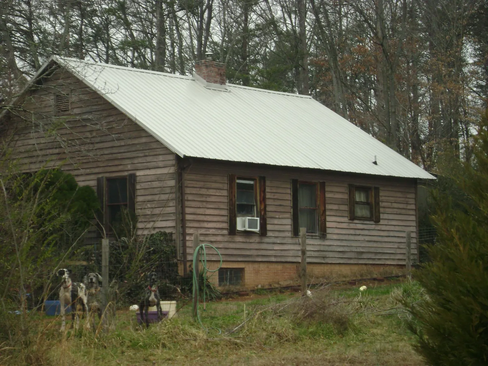 White metal roof on an old wood sided farmhouse, from a Metal Roof Installation job in Rockbridge